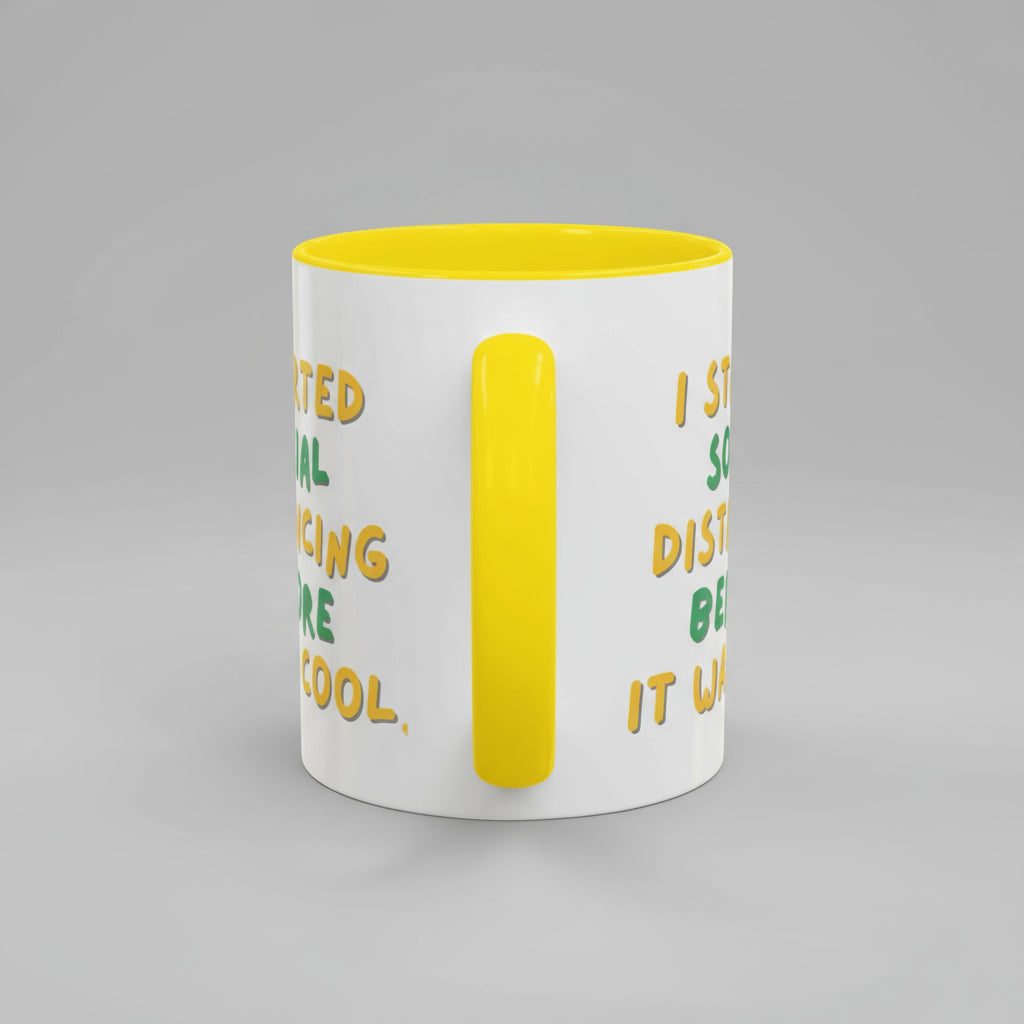 White mug with yellow interior and handle, featuring text on a white background