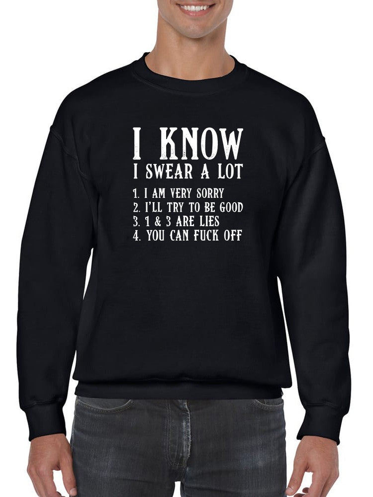 Black sweatshirt with white text worn by a person on a white background