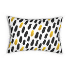 Decorative pillow with black and yellow abstract pattern on a white background