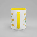 White mug with yellow interior and handle, featuring text on a white background