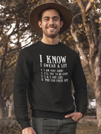 Man wearing a black sweatshirt with text outdoors