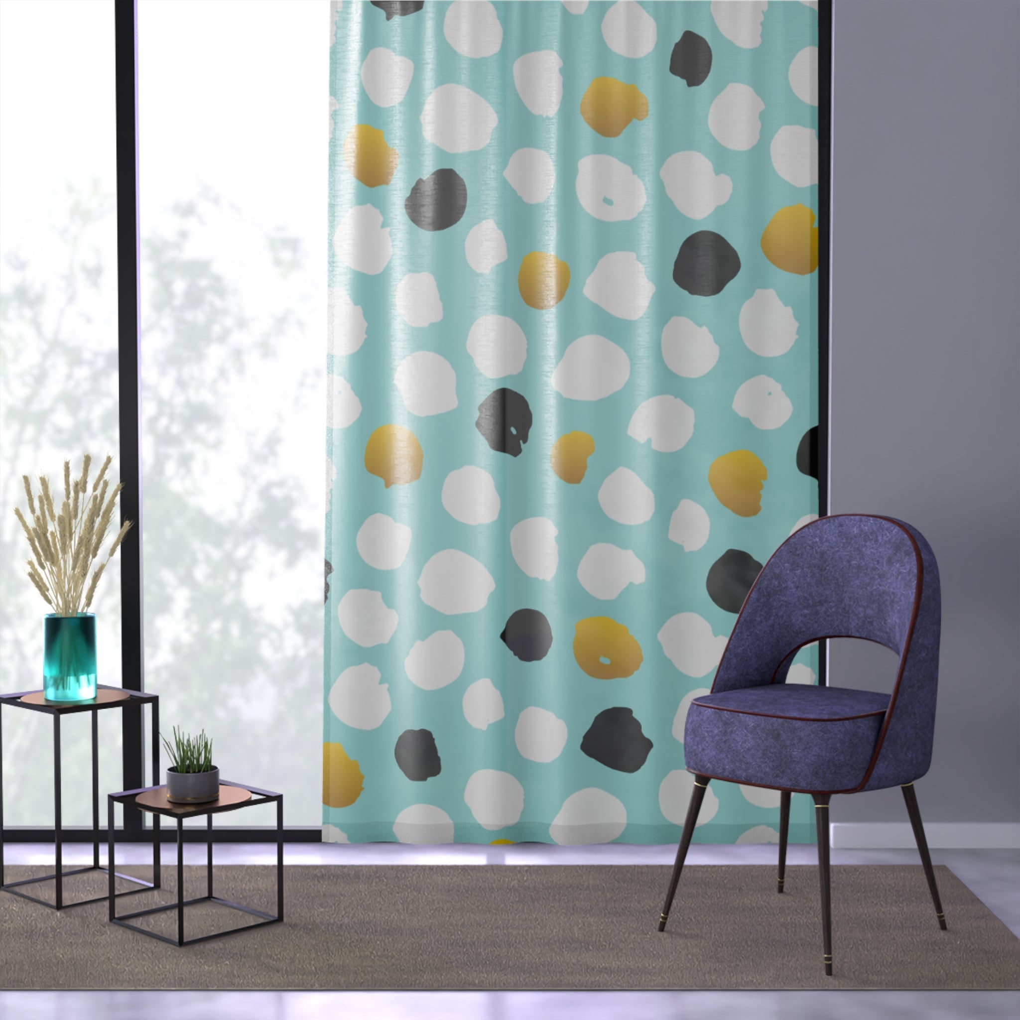 Polka dot curtain with a blue chair and small tables in a room.