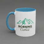 White mug with blue handle and interior, featuring green mountain design and text on a white background