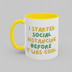 White mug with yellow handle and interior, featuring a humorous text quote.