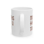 White mug with rose gold text on a white background