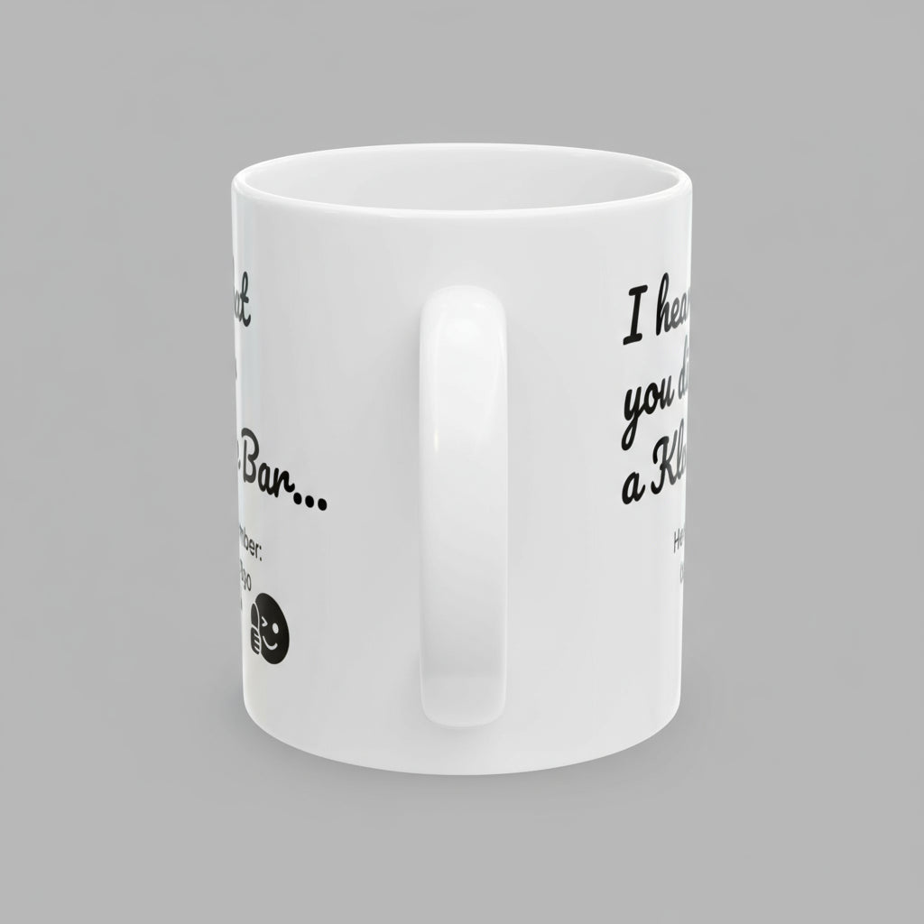 White mug with black text and a small graphic on a white background