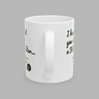 White mug with black text and a small graphic on a white background