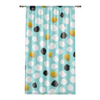 Curtain with colorful polka dot pattern on a light blue background