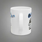 White mug with cartoon character and text on a white background