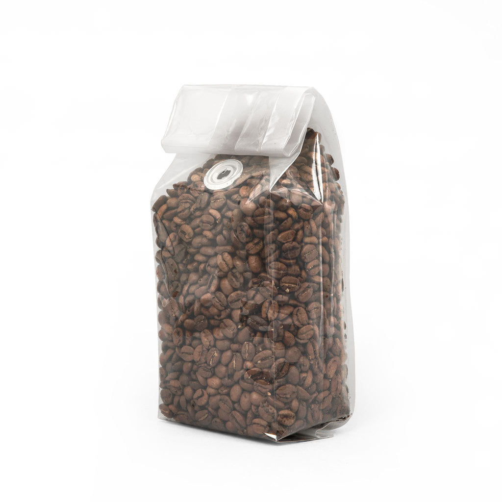 Clear bag filled with coffee beans on a white background