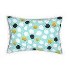 Decorative pillow with polka dot pattern on a light blue background