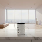 White mug with black interior and text on a white background