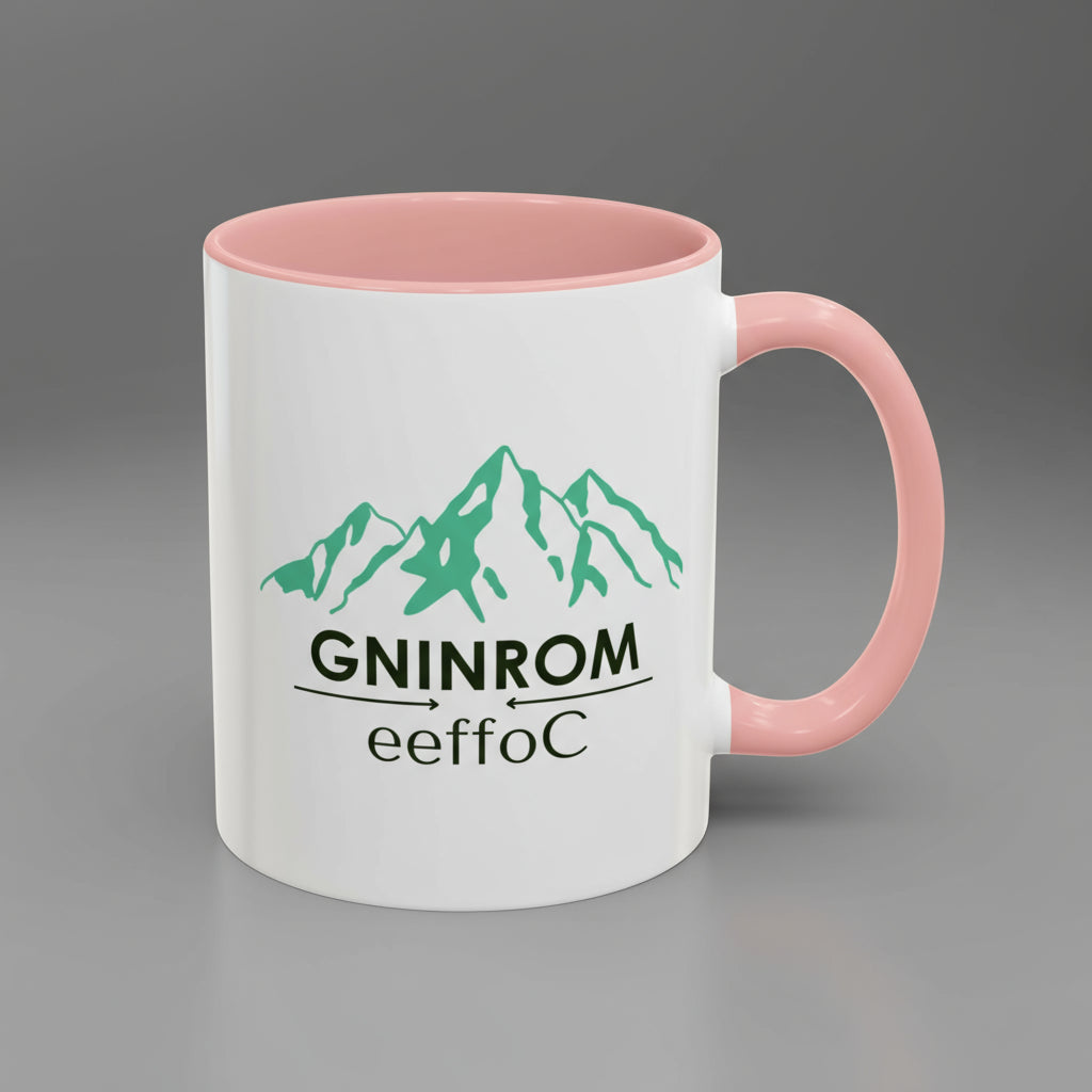 White mug with pink interior and handle featuring green mountain graphic and text.