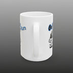 White mug with cartoon character and text on a white background