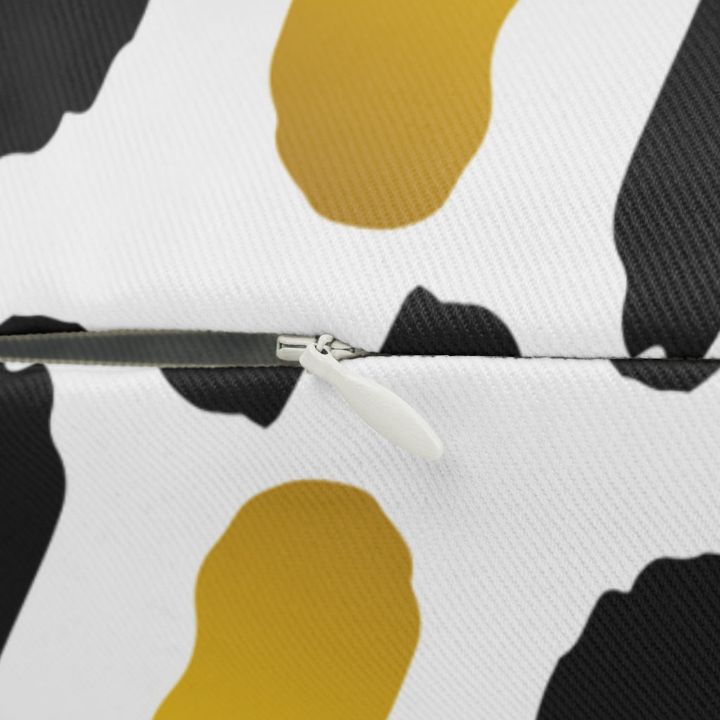 Close-up of a bag with a zipper on a white background with black and yellow abstract shapes.