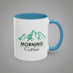 White mug with blue interior and handle featuring green mountain graphic and text.
