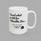 White mug with black text and phone number on a white background